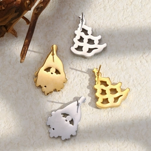 Christmas stud earrings with gold and silver Santa and tree silhouettes on a neutral background