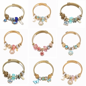 Gold stainless steel charm bracelets with star, sun, and flower mosaic pendants