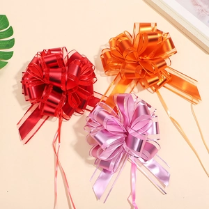 Detailed view of red, orange, and purple metallic matte gift bows for gift wrapping
