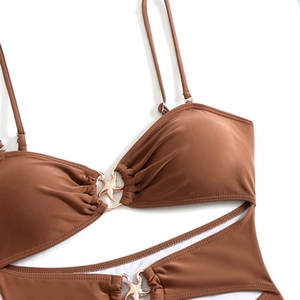 Macro-opname van karamelbruin badpak met decoratieve gouden zeester gesp detail op de stof