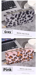 Detailed view of plush leopard print pouches in grey and pink with metal zippers