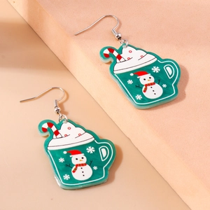 Close-up of festive Christmas earrings featuring snowman, hot cocoa, and candy cane charms