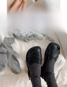 Detail of grey slouch socks showing wide ribbed cuff and seamless knit texture for comfort