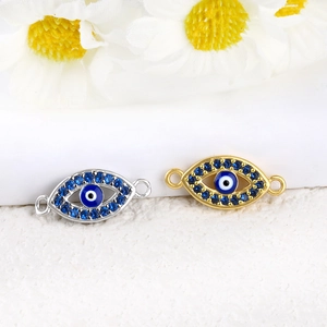 Macro shot of 14K gold and silver plated evil eye connector charms for DIY jewelry making