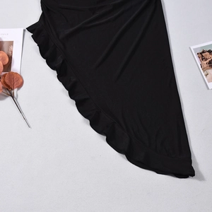 Detail of black off-shoulder bodycon dress featuring ruffled hem and textured fabric