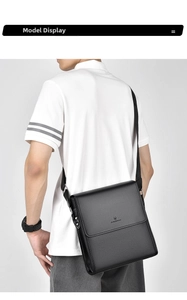 Rear view of a black pebble grain leather messenger bag on a male model with strap
