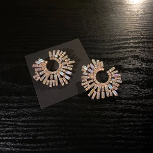 Detailed macro view of silver needle fan-shaped earrings with colorful iridescent rhinestones