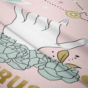Detailed macro view of soft pink bohemian tapestry fabric with artistic floral and star prints