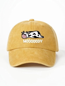 Close-up of mustard yellow corduroy baseball cap featuring Moooody cow embroidery
