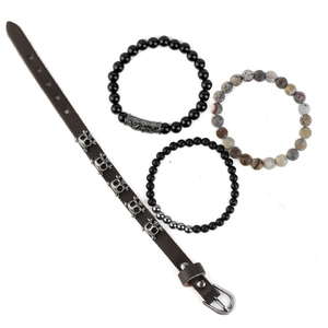 Detail of 4-piece multilayer bracelet set with tiger eye beads and leather skull charms