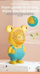 Close-up of cute bear mini fan showing two-speed wind control and golden bow detail