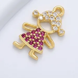 Macro view of gold plated brass girl pendant with pink gems and white zircon inlay