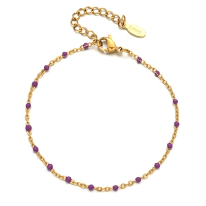 Detail of gold stainless steel bracelet with purple beads and lobster clasp closure