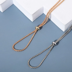 Minimalist box chain eyewear straps in gold and silver with adjustable sliding buckles