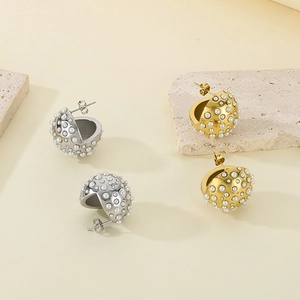 Exaggerated golden and silver hemispherical stud earrings with white pearls