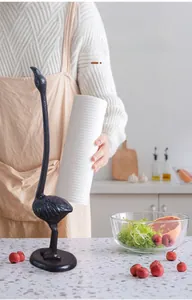 Detail of vintage cast iron ostrich paper towel holder with stable round base for kitchen