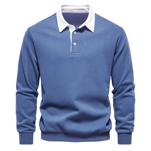Detail of blue polo sweatshirt featuring a white contrasting collar and ribbed cuffs