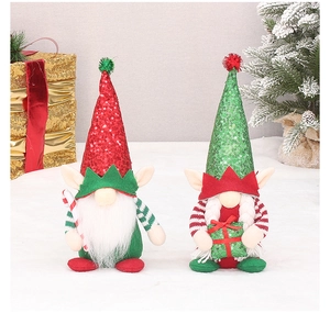Detail of sequin hats and festive props on plush Christmas gnomes decorations