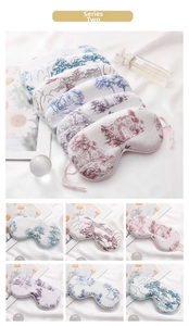 Close-up of printed faux silk sleep masks with traditional Chinese landscape patterns