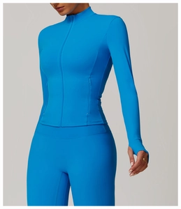 Close-up of vibrant blue zip-up yoga jacket with thumbhole cuffs and high stand collar