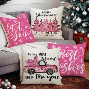Set of four pink Christmas linen pillow covers featuring festive truck and tree prints
