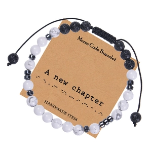 Close-up of white turquoise and lava stone Morse code bracelet on gift display card