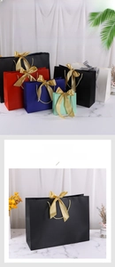 Multi-colored paper gift bags with elegant ribbon bows and matching woven handles