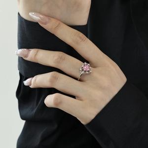 Detail of elegant S925 silver ring featuring a pink heart zircon worn on a hand
