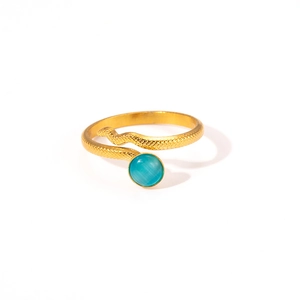 Detailed close-up of golden snake ring with textured surface and blue gemstone inlay