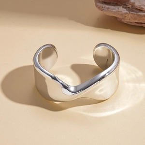 Detailed view of silver polished wavy cuff bracelet with minimalist modern design