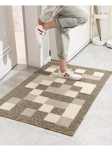 Macro view of woven brown and beige checkered door mat on tiled floor with a person stepping