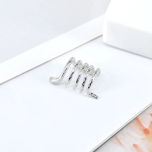 Macro shot of silver snake-scale textured multi-layer ear cuff in minimalist style