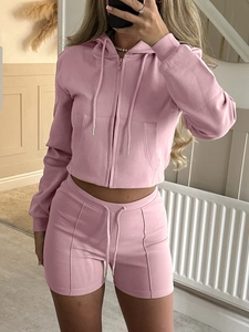 Women's pink two-piece athletic lounge set with hooded zip jacket and drawstring shorts