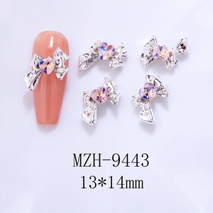 Detail of 13x14mm bow heart nail art charm with pink crystal rhinestone on silver base