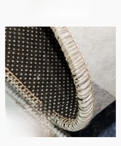 Detail of 6mm thick anti-slip kitchen rug with grey plush surface and beige stitching