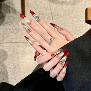 Red French long almond press-on nails with champagne cat-eye finish and cross crystals