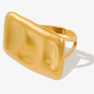 Detail shot of wide gold open cuff bracelet with irregular wave texture surface