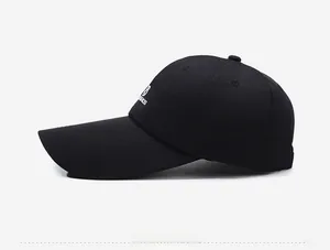 Side view of black canvas baseball cap with long brim and white embroidered B logo