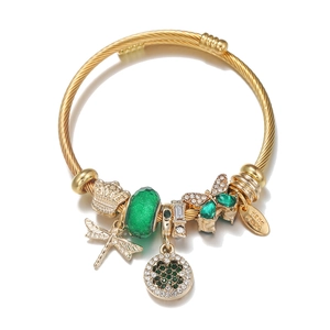 Golden butterfly and four-leaf clover charm bracelet made of stainless steel with green gems