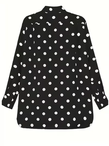 Detailed view of the lapel and lantern sleeve cuffs on a black polka dot oversized shirt