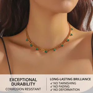 Close-up of gold stainless steel chain necklace featuring vibrant green heart crystals