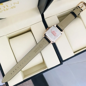Detail view of the stainless steel back case and genuine calfskin leather strap on women watch
