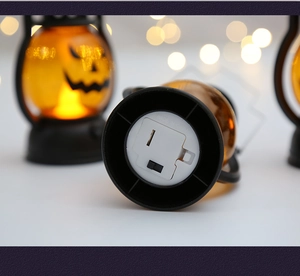 Detail view of the battery compartment and power switch on a Halloween pumpkin lantern