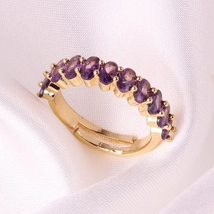Detail of gold plated ring featuring oval purple zircons and adjustable opening