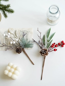 Detailed view of Christmas berry picks with pine cones and green needles for festive decor
