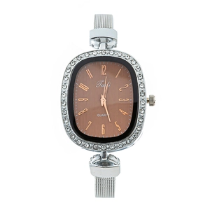 Detail of silver mesh band watch with brown oval dial and sparkling crystal bezel