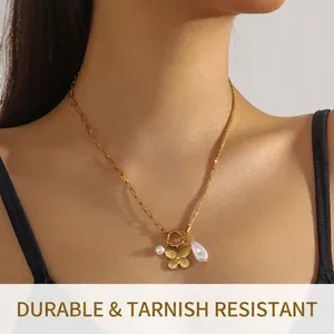 Asymmetric gold necklace with butterfly and pearl pendants shown on an Asian female model