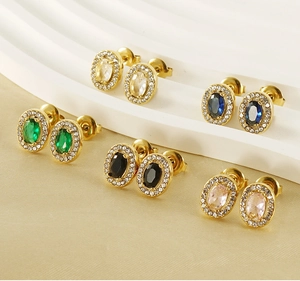 Detailed showcase of oval zircon stud earrings in gold finish with halo diamond setting