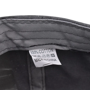 Detail view of internal wash label showing 100% cotton material on washed cotton baseball cap