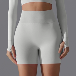 Close-up of high-waisted seamless gray yoga shorts with ribbing and thumbhole crop top